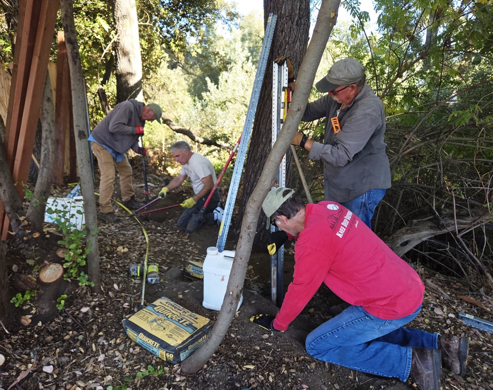 Clem, Charles, Carl and Cory digging holes and lining it up.